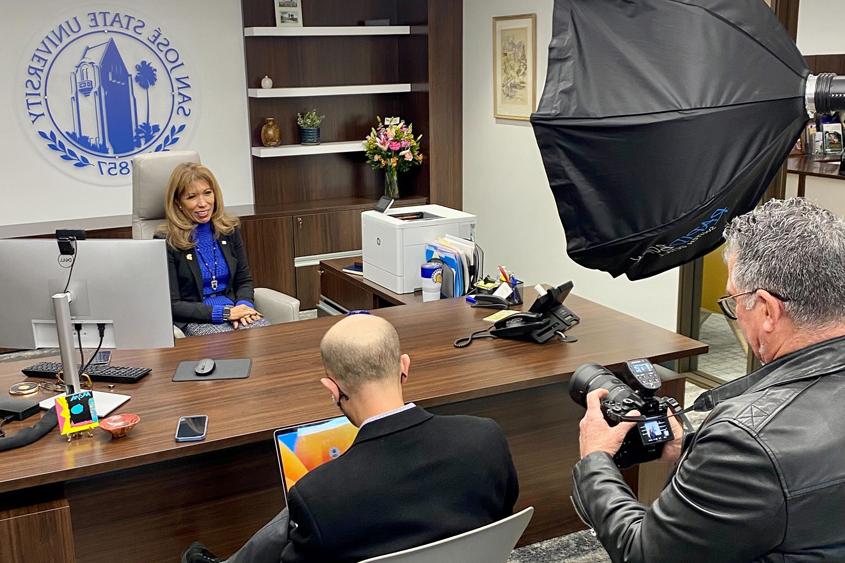 President Teniente-Matson speaking with media folks in her office.